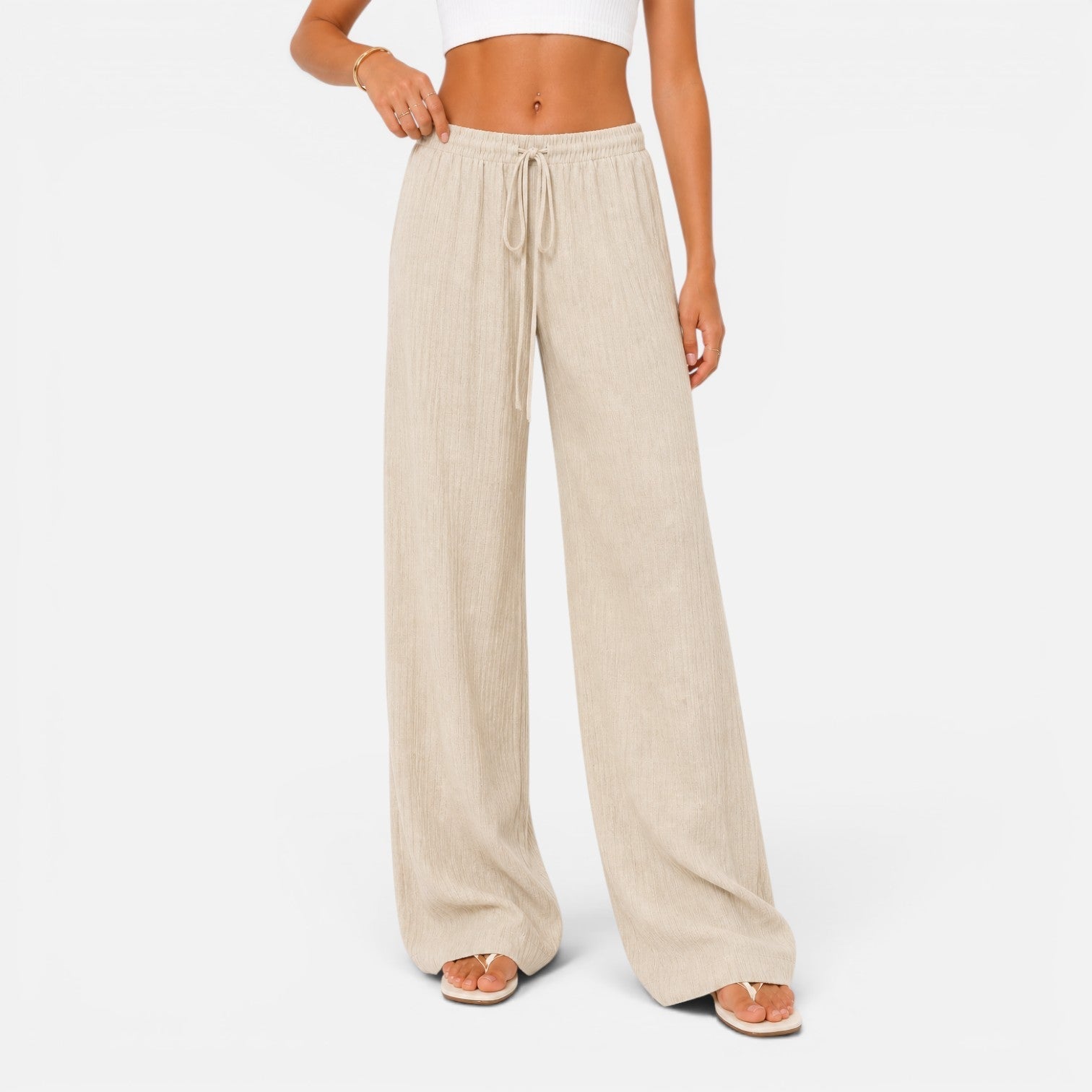 Szerokie spodnie damskie w kolorze beżowym, comfort fit – Diamila Moda